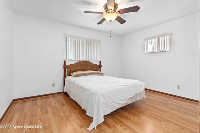 662 Estaugh St NW, Palm Bay, FL 32907 - bedroom with baseboards, light wood-style floors, and ceiling fan