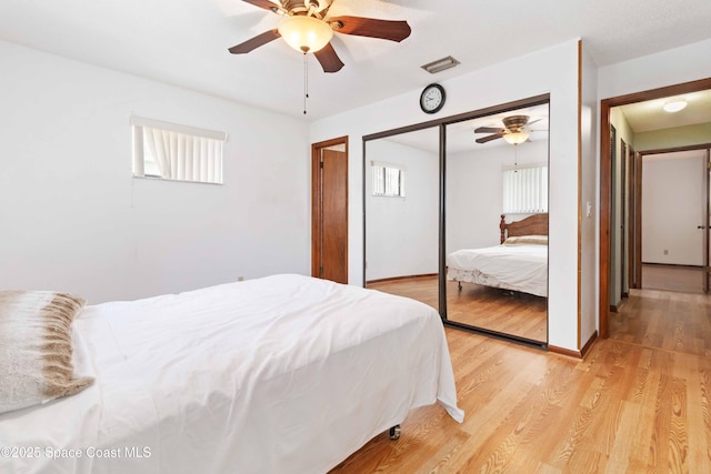 662 Estaugh St NW, Palm Bay, FL 32907 - bedroom featuring a closet, light wood finished floors, and a ceiling fan