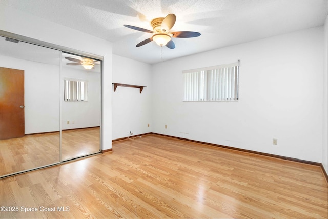 662 Estaugh St NW, Palm Bay, FL 32907 - unfurnished bedroom with light wood-style flooring, baseboards, ceiling fan, and a closet