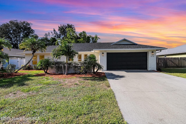 670 S Oak Park Cir E, Merritt Island, FL 32953 - single story home with stucco siding, a garage, and driveway