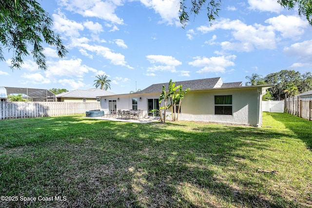 670 S Oak Park Cir E, Merritt Island, FL 32953 - rear view of property with stucco siding, a patio area, and a fenced backyard