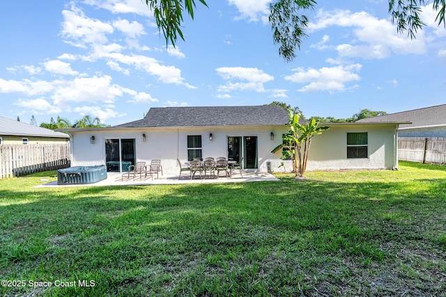 670 S Oak Park Cir E, Merritt Island, FL 32953 - rear view of property featuring stucco siding, a patio, and a hot tub