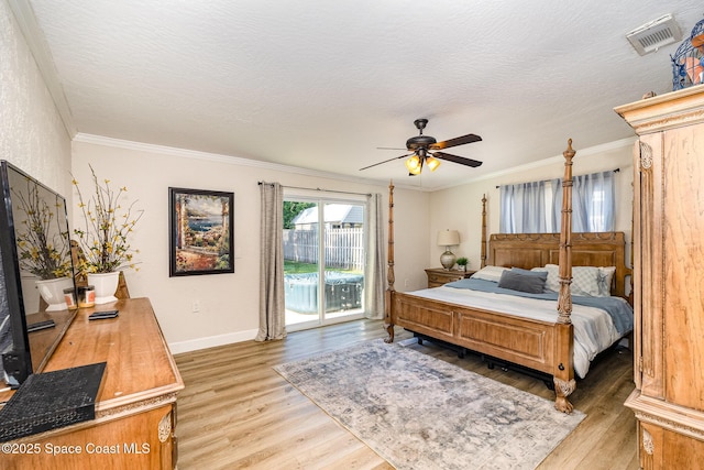 670 S Oak Park Cir E, Merritt Island, FL 32953 - bedroom with access to outside, light wood-style floors, crown molding, ceiling fan, and a textured ceiling