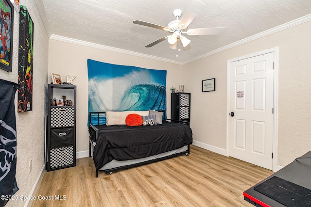 670 S Oak Park Cir E, Merritt Island, FL 32953 - bedroom with wood finished floors, ornamental molding, a textured ceiling, and a ceiling fan