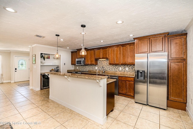 670 S Oak Park Cir E, Merritt Island, FL 32953 - kitchen with stainless steel appliances, light tile patterned floors, a breakfast bar area, crown molding, and light stone counters