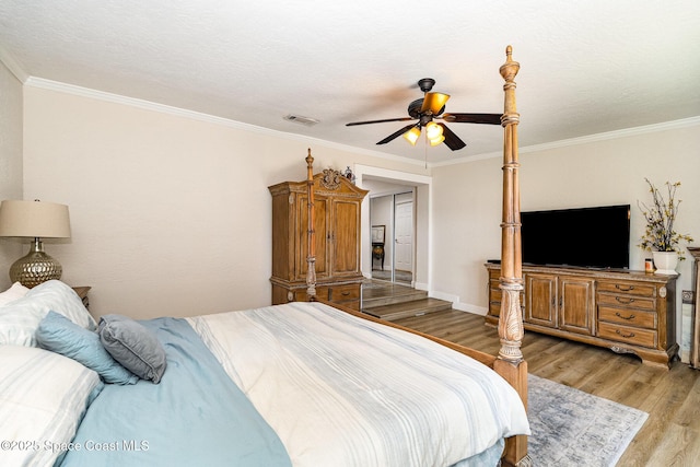 670 S Oak Park Cir E, Merritt Island, FL 32953 - bedroom with light wood-style floors, ornamental molding, and a ceiling fan