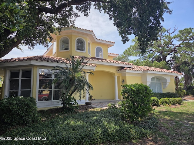 1999 S Misty Harbor Pl, Merritt Island, FL 32952 - mediterranean / spanish-style home featuring a tiled roof and stucco siding