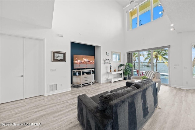 1999 S Misty Harbor Pl, Merritt Island, FL 32952 - living room featuring wood finished floors and a towering ceiling