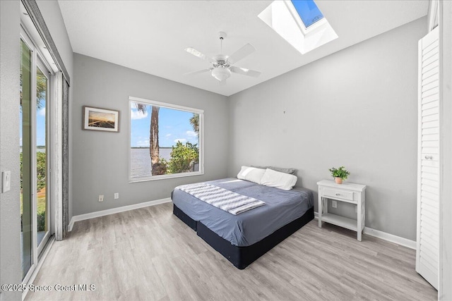 1999 S Misty Harbor Pl, Merritt Island, FL 32952 - bedroom with a skylight, wood finished floors, and ceiling fan