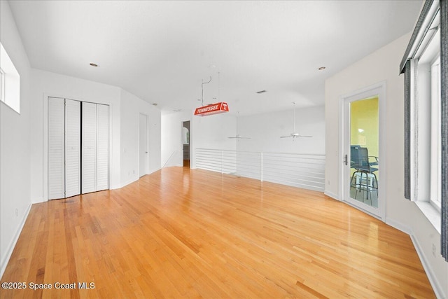 1999 S Misty Harbor Pl, Merritt Island, FL 32952 - unfurnished living room featuring wood finished floors and ceiling fan