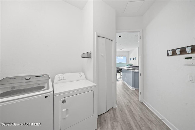 1999 S Misty Harbor Pl, Merritt Island, FL 32952 - laundry room with washer and dryer and light wood finished floors