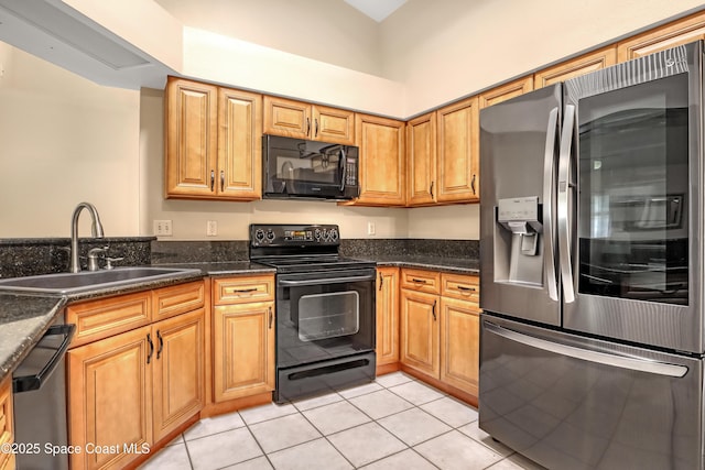 1486 Beche St SE, Palm Bay, FL 32909 - kitchen with black appliances, light tile patterned floors, and dark stone counters
