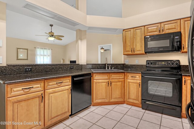 1486 Beche St SE, Palm Bay, FL 32909 - kitchen with black appliances, ceiling fan, dark stone countertops, light tile patterned floors, and high vaulted ceiling