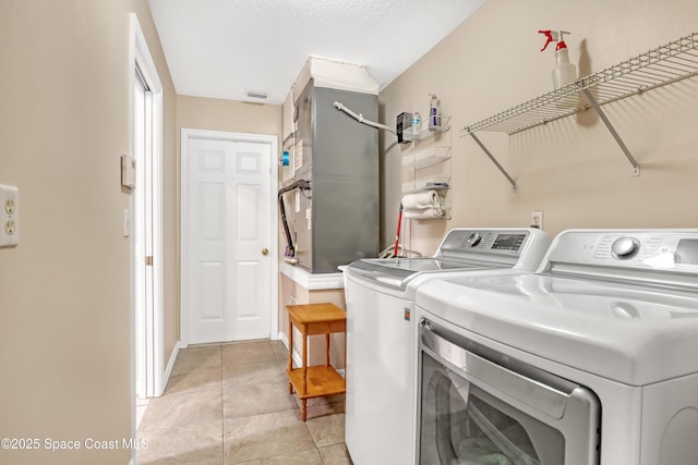 1486 Beche St SE, Palm Bay, FL 32909 - washroom featuring washing machine and clothes dryer and light tile patterned flooring