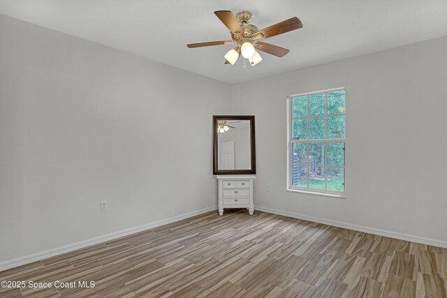 1486 Beche St SE, Palm Bay, FL 32909 - spare room with light wood-style floors and ceiling fan
