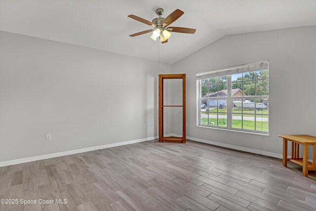 1486 Beche St SE, Palm Bay, FL 32909 - spare room featuring wood finished floors, a ceiling fan, and vaulted ceiling