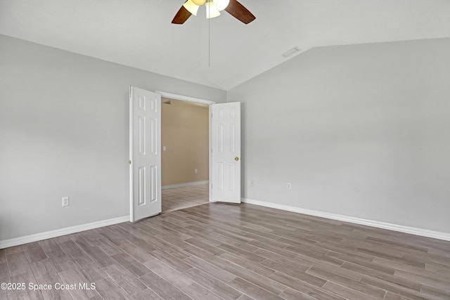 1486 Beche St SE, Palm Bay, FL 32909 - empty room with a ceiling fan, lofted ceiling, and wood finished floors