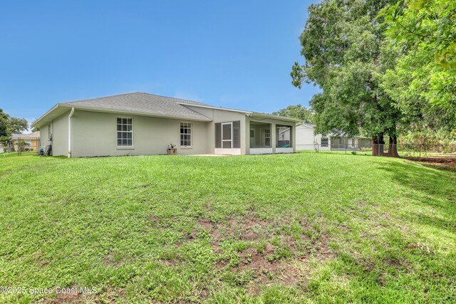 1486 Beche St SE, Palm Bay, FL 32909 - back of property with stucco siding and a sunroom