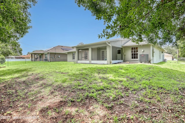 1486 Beche St SE, Palm Bay, FL 32909 - rear view of property featuring a sunroom and stucco siding