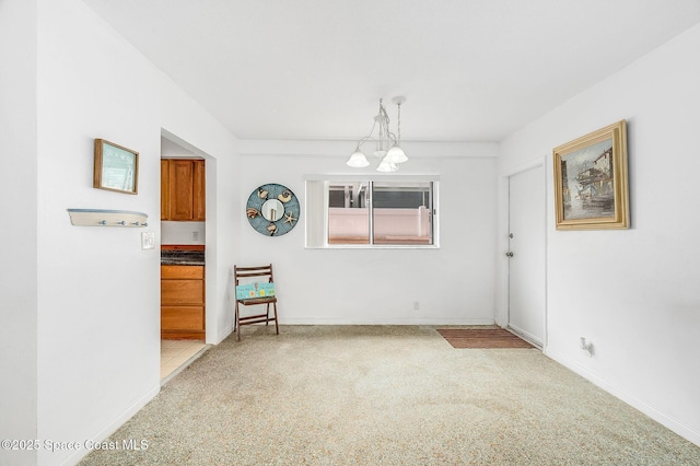 1700 Atlantic St Unit 1, Melbourne Beach, FL 32951 - empty room with a chandelier, light colored carpet, and baseboards