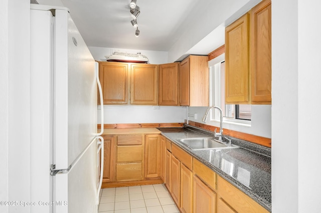 1700 Atlantic St Unit 1, Melbourne Beach, FL 32951 - kitchen featuring freestanding refrigerator, a sink, light tile patterned floors, and dark stone counters