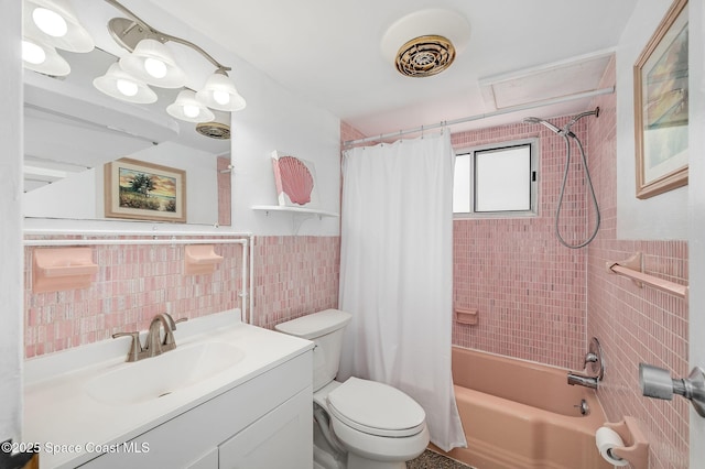 1700 Atlantic St Unit 1, Melbourne Beach, FL 32951 - full bathroom featuring tile walls, toilet, shower / bath combo with shower curtain, vanity, and a wainscoted wall
