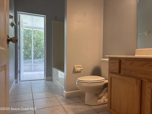 3197 Weyburn Ave SE, Palm Bay, FL 32909 - full bath featuring tile patterned floors, toilet, vanity, a tub, and baseboards
