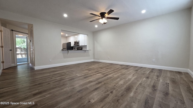 1880 Murrell Rd Unit E19, Rockledge, FL 32955 - unfurnished living room with baseboards, dark wood-style flooring, a ceiling fan, and recessed lighting