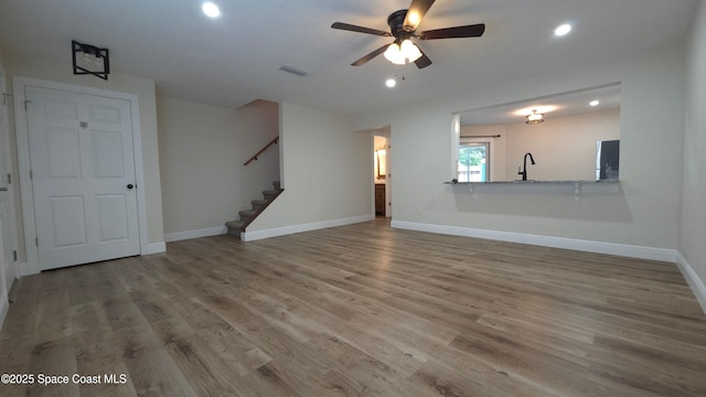 1880 Murrell Rd Unit E19, Rockledge, FL 32955 - unfurnished living room with baseboards, stairway, wood finished floors, a ceiling fan, and recessed lighting