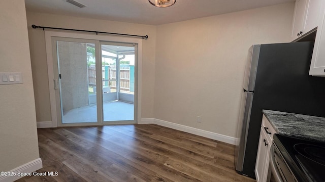 1880 Murrell Rd Unit E19, Rockledge, FL 32955 - kitchen featuring white cabinetry, baseboards, wood finished floors, and stone counters