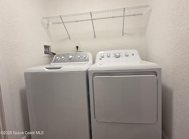 1880 Murrell Rd Unit E19, Rockledge, FL 32955 - laundry room featuring separate washer and dryer and a textured wall