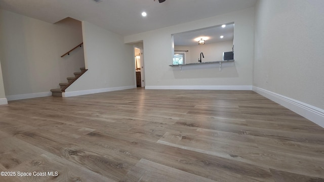 1880 Murrell Rd Unit E19, Rockledge, FL 32955 - unfurnished living room featuring stairway, wood finished floors, baseboards, and recessed lighting