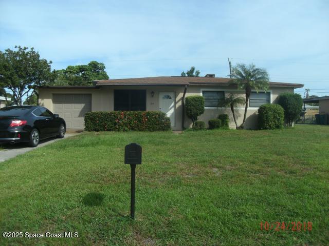 314 Princeton Ave, Melbourne, FL 32901 - ranch-style home featuring an attached garage, a front lawn, stucco siding, and driveway