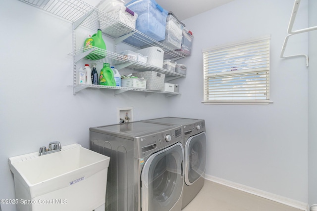 2039 Snapdragon Dr NW, Palm Bay, FL 32907 - laundry area with washer and clothes dryer and baseboards