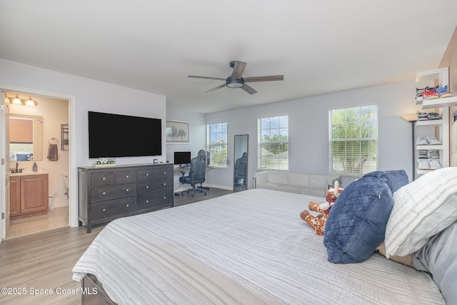 2039 Snapdragon Dr NW, Palm Bay, FL 32907 - bedroom with wood finished floors, an office area, ensuite bath, and ceiling fan