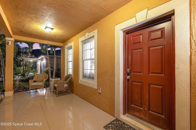 2039 Snapdragon Dr NW, Palm Bay, FL 32907 - view of exterior entry featuring stucco siding and covered porch