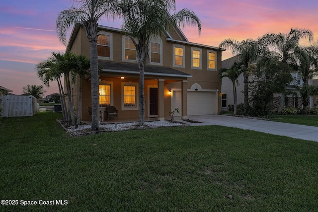2039 Snapdragon Dr NW, Palm Bay, FL 32907 - traditional-style house with stucco siding, a garage, concrete driveway, and covered porch