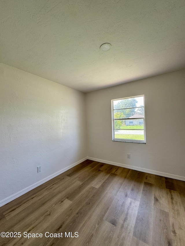 1961 Academy St NE, Palm Bay, FL 32905 - unfurnished room with wood finished floors and a textured ceiling