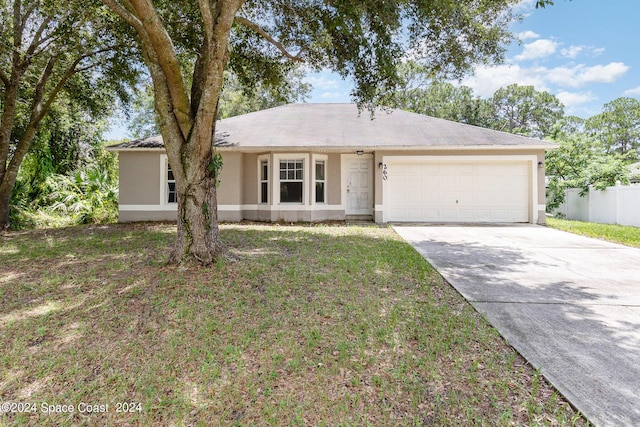260 Hinchman St SE, Palm Bay, FL 32909 - ranch-style home with an attached garage, stucco siding, and concrete driveway