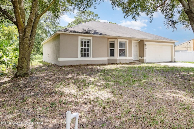 260 Hinchman St SE, Palm Bay, FL 32909 - view of front of house featuring an attached garage, stucco siding, and concrete driveway