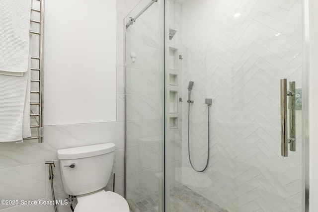 333 N Atlantic Ave Unit 333, Cocoa Beach, FL 32931 - bathroom with a towel warming rack, a stall shower, and toilet