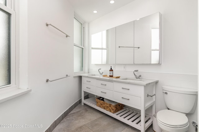 333 N Atlantic Ave Unit 333, Cocoa Beach, FL 32931 - bathroom with double vanity, toilet, and recessed lighting