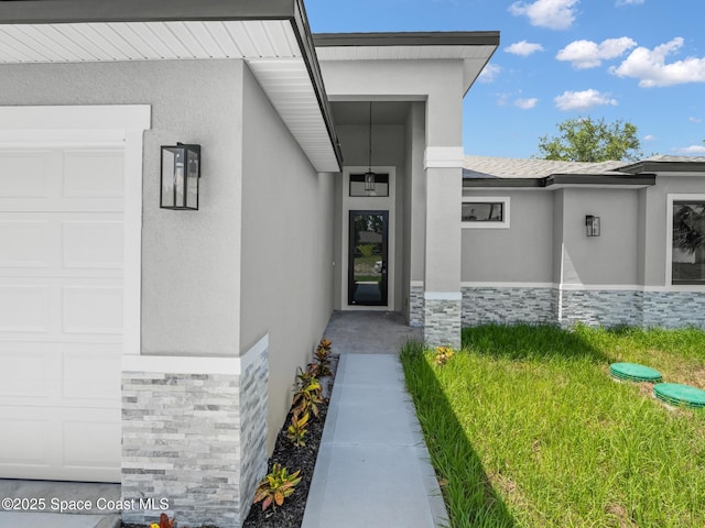 337 Fifer St SE, Palm Bay, FL 32909 - entrance to property with stone siding, an attached garage, and stucco siding