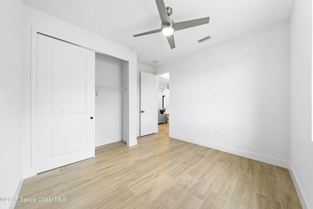 337 Fifer St SE, Palm Bay, FL 32909 - unfurnished bedroom with a closet, light wood finished floors, and ceiling fan