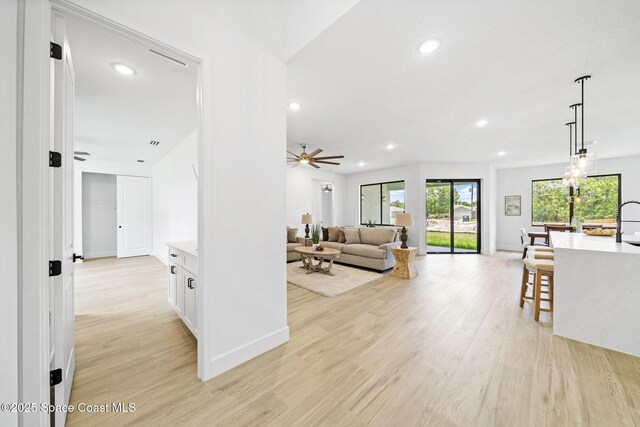 337 Fifer St SE, Palm Bay, FL 32909 - living area with recessed lighting, light wood finished floors, and a ceiling fan