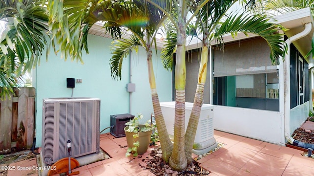 2178 Redwood Cir NE, Palm Bay, FL 32905 - view of home's exterior with central air condition unit, a sunroom, and stucco siding