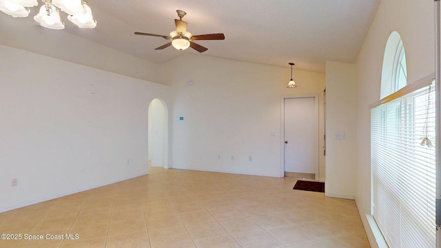 2178 Redwood Cir NE, Palm Bay, FL 32905 - spare room featuring arched walkways, vaulted ceiling, ceiling fan, light tile patterned floors, and a chandelier