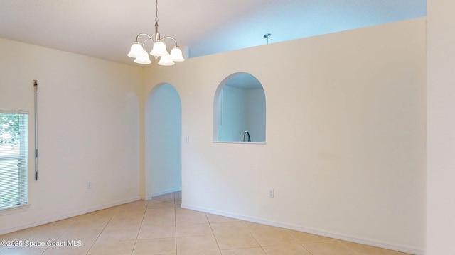 2178 Redwood Cir NE, Palm Bay, FL 32905 - unfurnished room featuring vaulted ceiling, a chandelier, light tile patterned floors, arched walkways, and baseboards