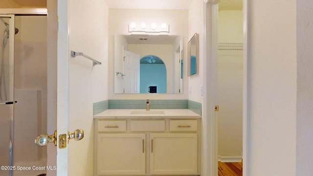 2178 Redwood Cir NE, Palm Bay, FL 32905 - full bathroom featuring a shower stall, vanity, decorative backsplash, and a spacious closet
