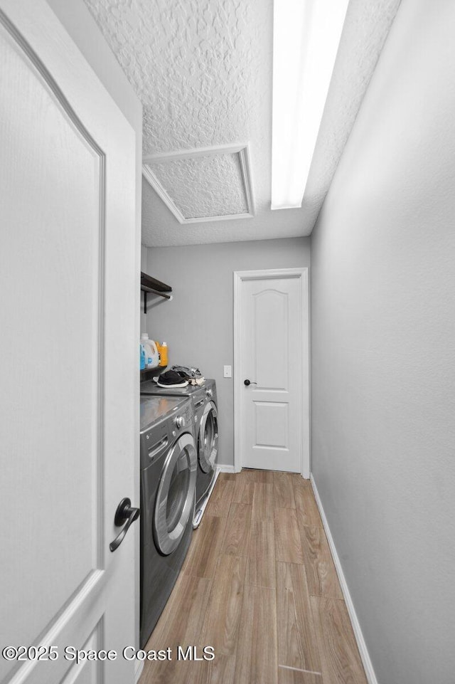 1236 Foxridge Pl, Melbourne, FL 32940 - washroom with washer and dryer, wood finished floors, and a textured ceiling